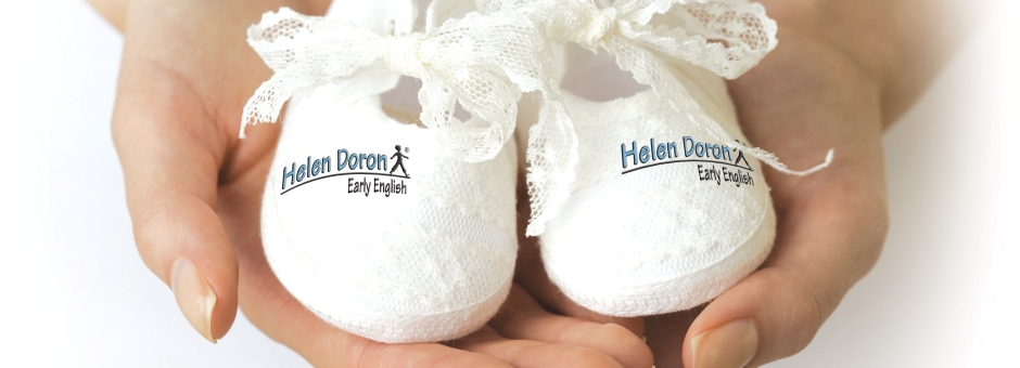 Close up of woman holding baby shoes